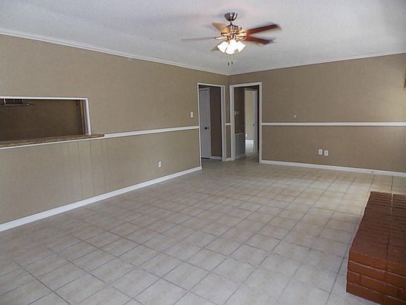 3rd view of living room looking into kitchen, foyer and hallway