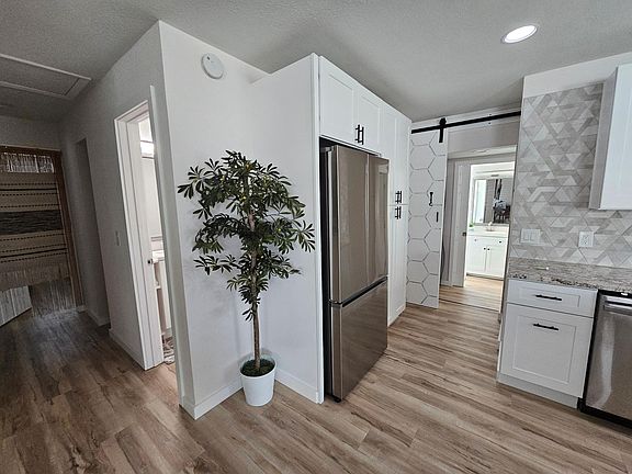 Barn door leads to laundry room and converted Garage Studio Apartment (which has it''s own separate entrance)