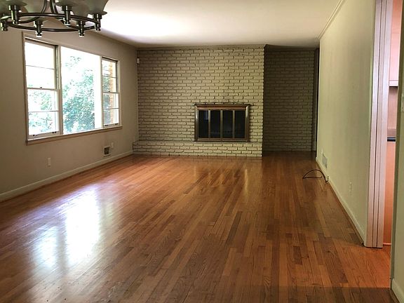Living room/dining room with gas fireplace. Hardwood floors