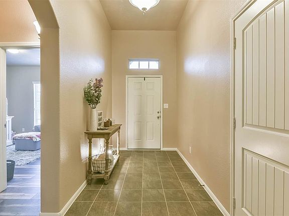 Two bedrooms are located right off the entryway and the access to the 2 car garage