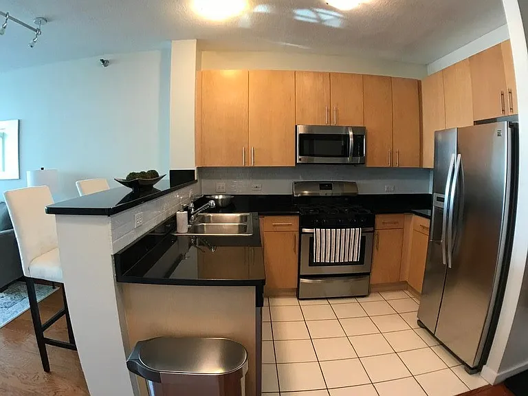 Kitchen breakfast bar, tile backsplash and stainless steel appliances