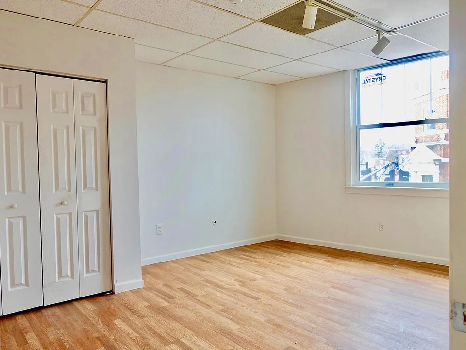 BEDROOM _ Bright, updated room featuring new flooring, modern double-pane sliding windows, and convenient closet space.