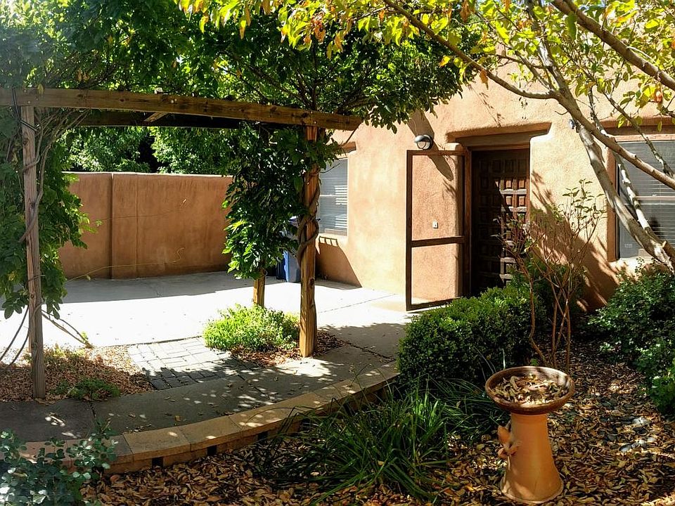 Front patio garden with gated parking spot