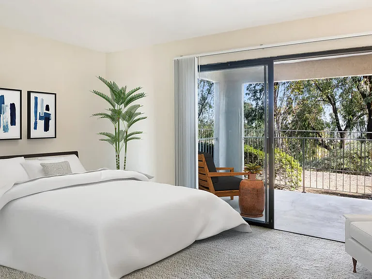 Carpeted Living Room with Balcony