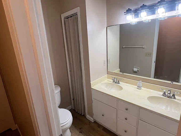 This is the upstairs hall bathroom with dual vanity and bathtub. All new LVP flooring! New lighting! New hardware! Freshly painted!