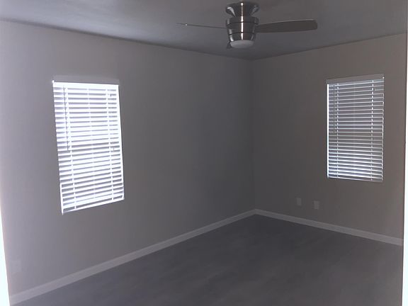 Bedroom with new ceiling fan and 2 blinds