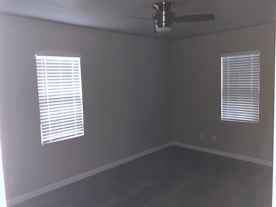 Bedroom with new ceiling fan and 2 blinds