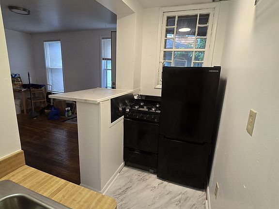small kitchen with new floor and breakfast nook