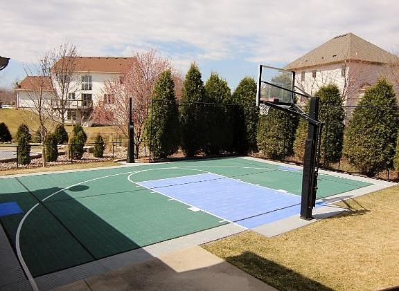 The back yard features a full sport court to entertain the whole family! Play basketball, practice batting and golf, even turn into a winter ice rink!
