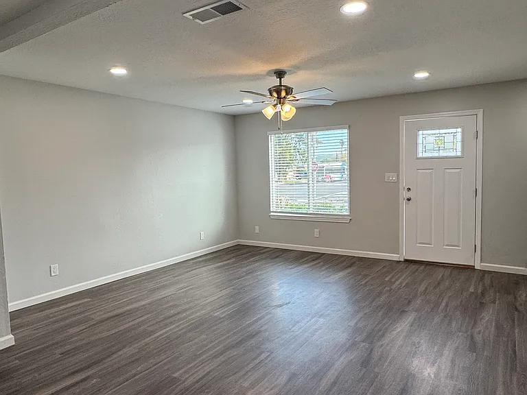 Living room area with large front window for plenty of natural lighting