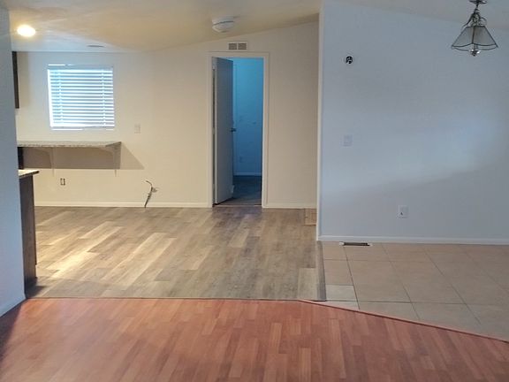 front room looking into kitchen area. laundry is behind that white wall.