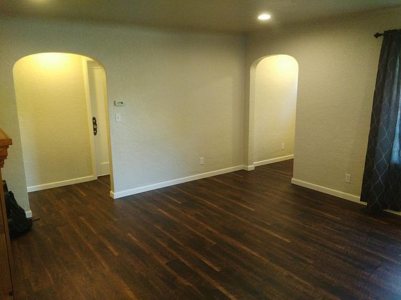 Living room, showing interior charm. Note the arched walkways and antique doorknobs. This home has character!