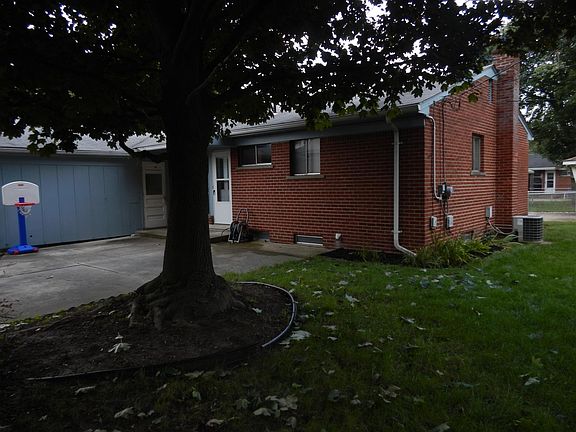 Backyard showing side door and garage entrance