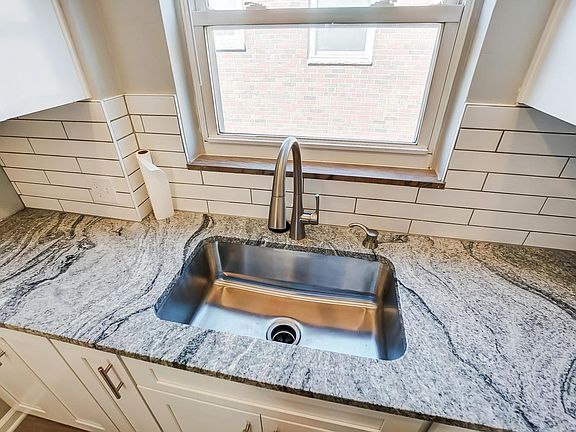Granite countertops and stainless steel skink.