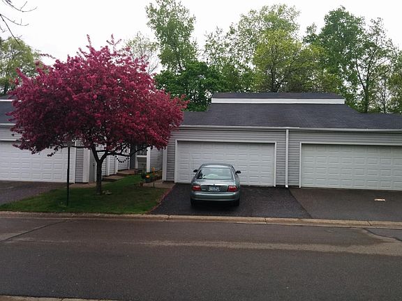Front view of the house in spring. The unit has a blossom tree.