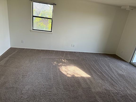 large living area with slider door access to outdoor porch with sweeping views