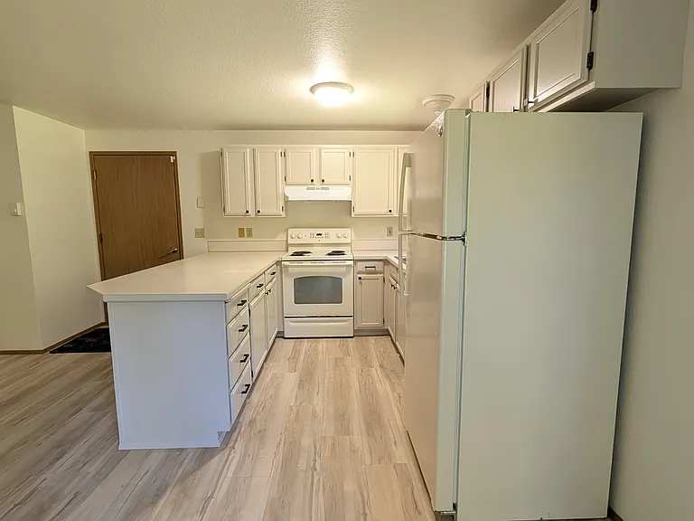 Kitchen and door leading into garage