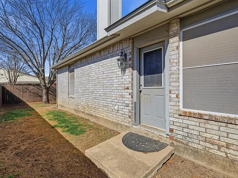 Doorway to property with brick siding