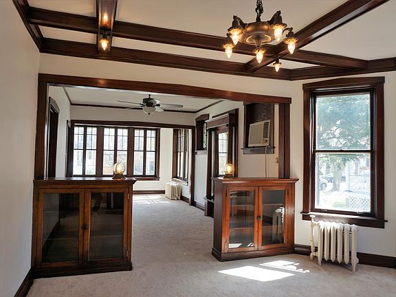 Large living room connected to dining room with original built-ins