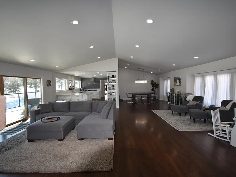 Main floor living, sitting, reading nook, dining (back right), kitchen (back left) - vaulted ceilings