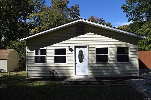 Front sunroom of house. Storage shed in left of picture not included.
