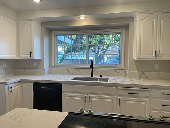White cabinets with pull out trays. Brand new Quartz countertop.
