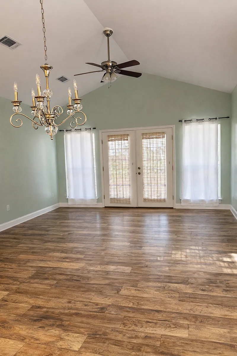 Photo of the living room in the background along with the french doors. The dining area is in the foreground. - 86 Summer Breeze Ln