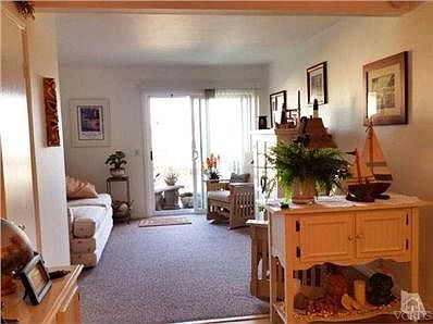 Living room with scraped ceilings, carpet