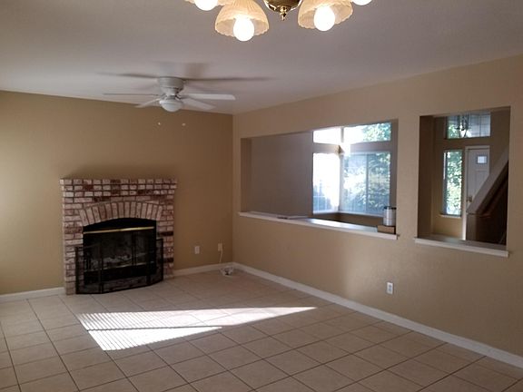 Family room with wood burning fireplace.