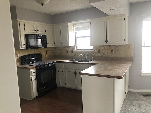 We are adding Calcutta white countertops ( this is the old outdated one) and adding a beautiful new white backsplash (it is torn out now- getting a fresh backsplash next week) with dark grey grout.