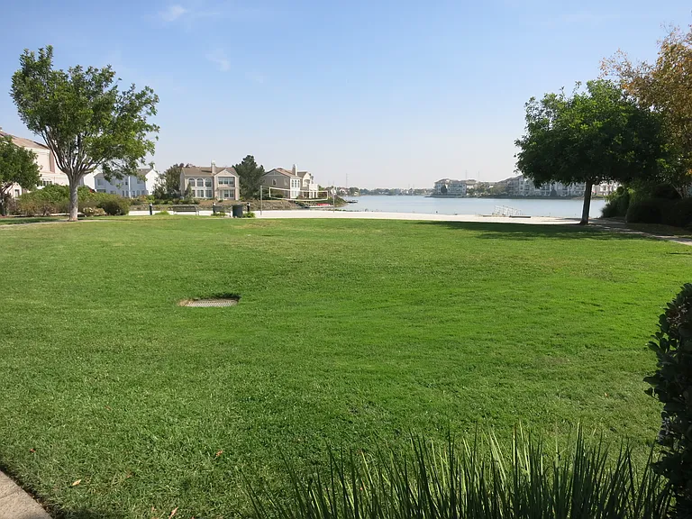 Community park with adjacent beach volleyball area and widewater lagoon
