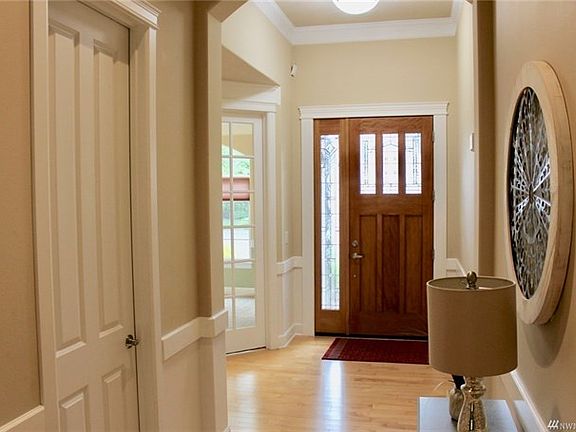 Lovely entry with hardwood floors and crown molding.  Powder room off to the left.