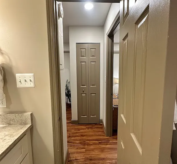 Hallway to enter bathroom and bedroom,including another custom closet, great for coats or cleaning supplies.