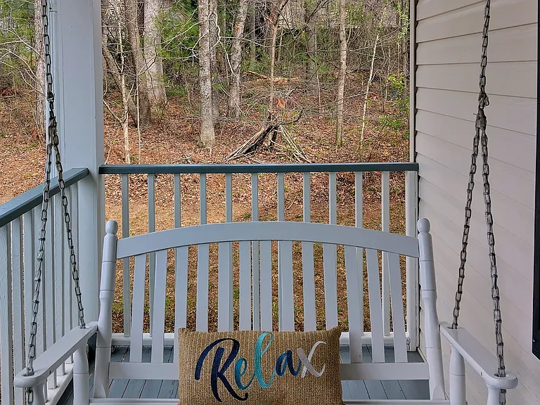 Sit down, relax, and enjoy the beautiful sounds of nature while swaying on the porch swing.