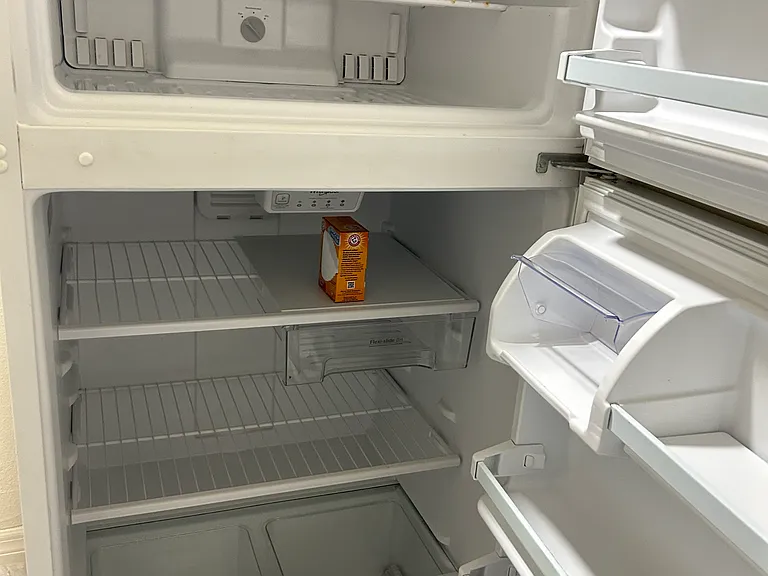Full-size refrigerator with freezer and ample food storage.