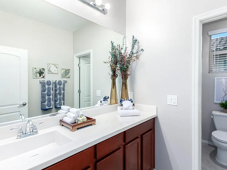 3rd hallway bath with another shower tub combination. Very long counter for all of your beauty products.