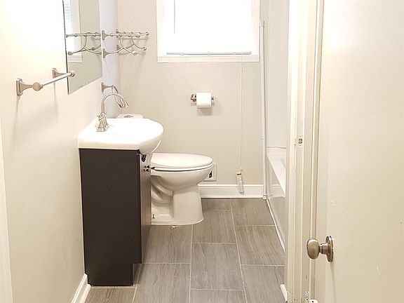 Fully renovated bathroom - new tile flooring, new paint, new sink/vanity/mirror, new toilet, new tub