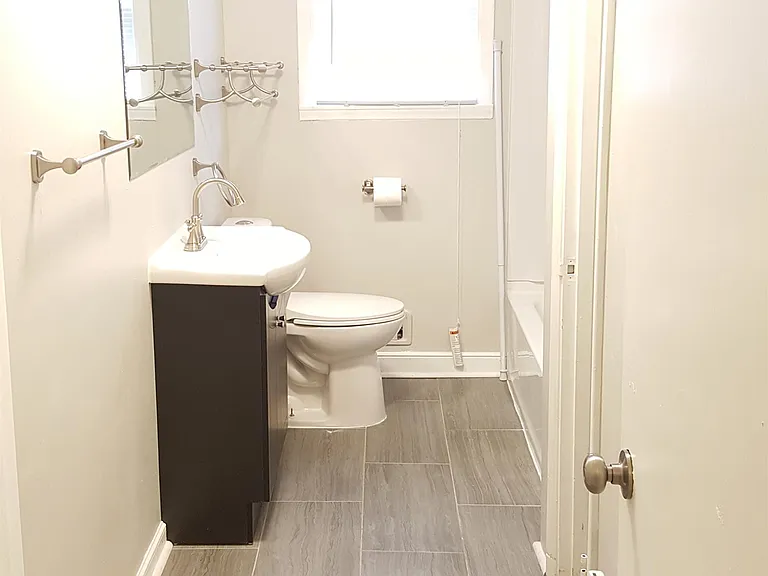 Fully renovated bathroom - new tile flooring, new paint, new sink/vanity/mirror, new toilet, new tub