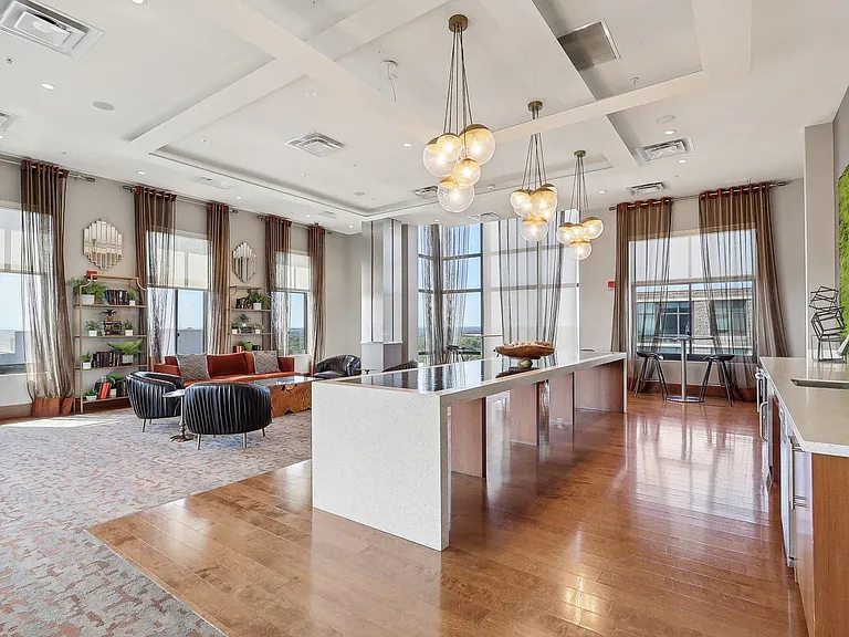 a large room with a kitchen and a large window