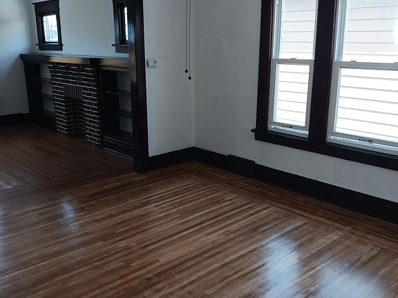 Dining room with refinished hardwood floors & ceiling fan/light.