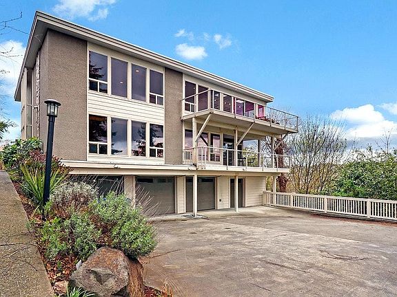 Driveway at end of cul-de-sac with parking outside and in garage.