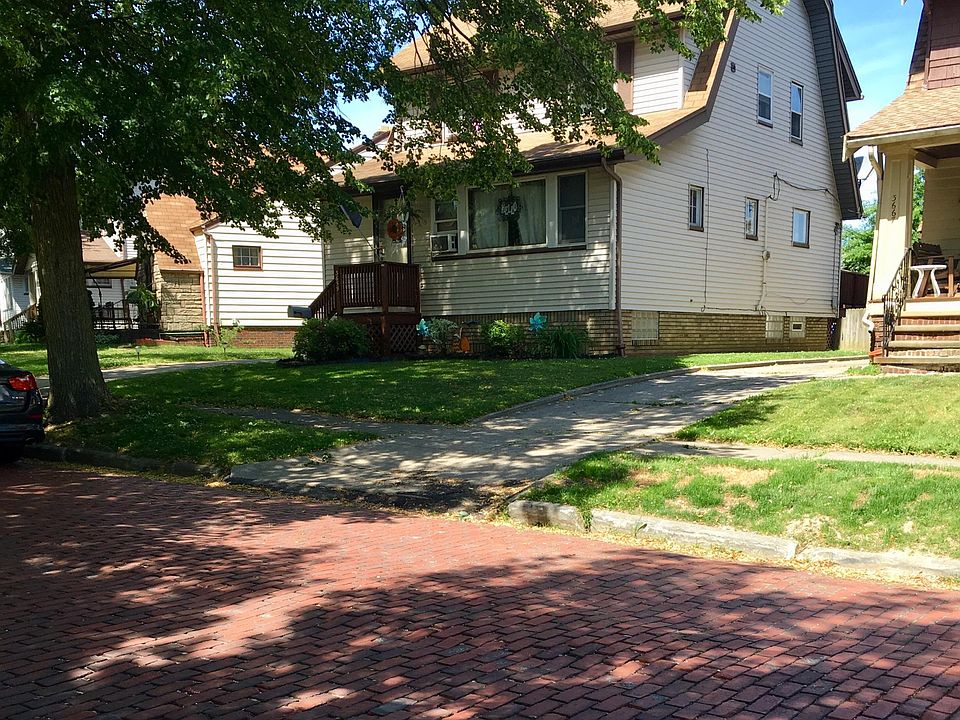 Front of house, highlighting rare brick street.