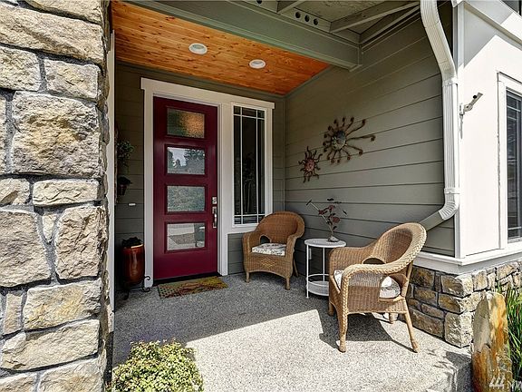 Inviting entry with modern glass door and natural wood soffit that adds warmth to the design