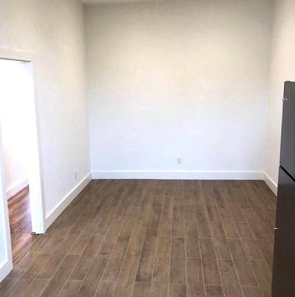 Living area attached to kitchen (tall ceilings with recessed LED lights)