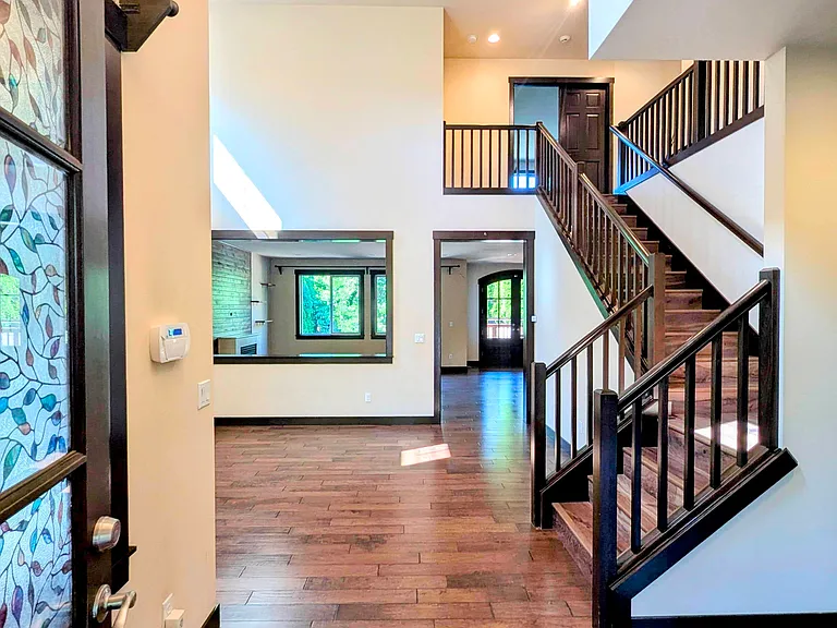 Entrance door opens into high ceiling Foyer and dinning room