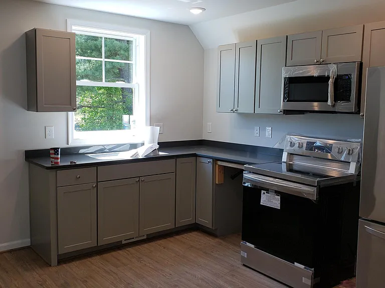 Kitchen when under construction, now has additional upper and lower cabinets and dishwasher.