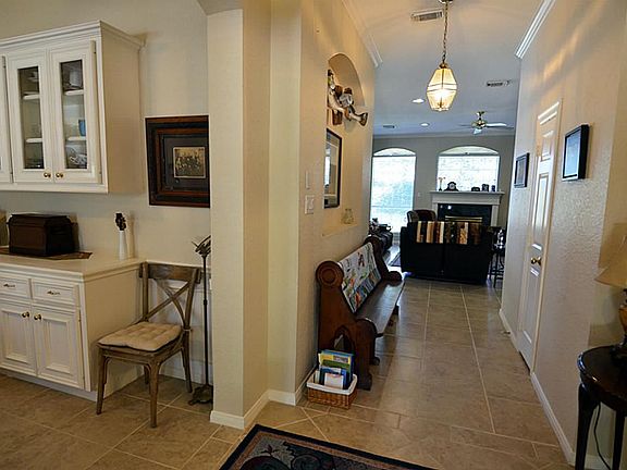 Entry to the home is a wide hallway with art niche for your favorite picture as well as room for a f