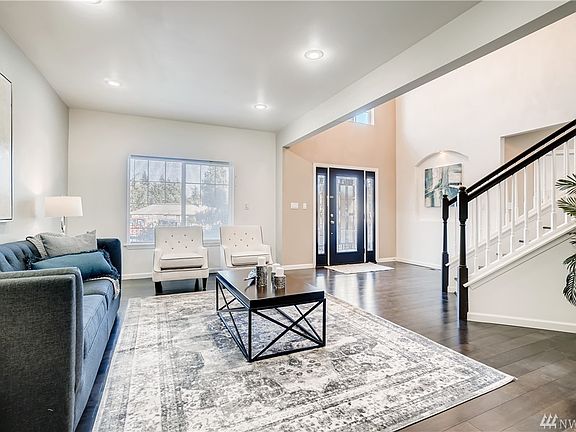 The large open formal living room to the left of the grand entrance. 