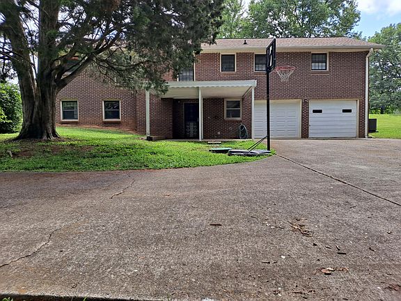Back of house shows separate door entrance into Basement Mother-n-law Suite (off covered patio), & oversized double car garage