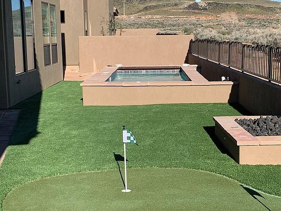 Pool (automated cover), firepit, and putting green in the yard.